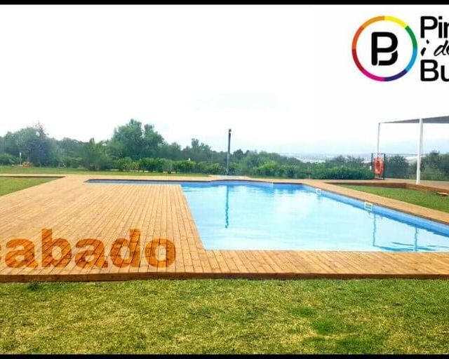 Pintures i decoració Bustins piscina con piso de madera